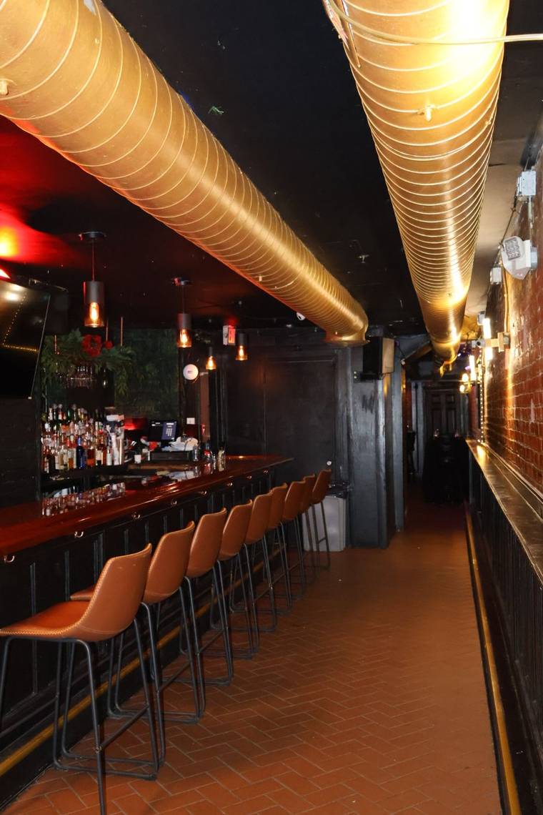 The bar at The Waiting Room in Hoboken — space held for smaller groups